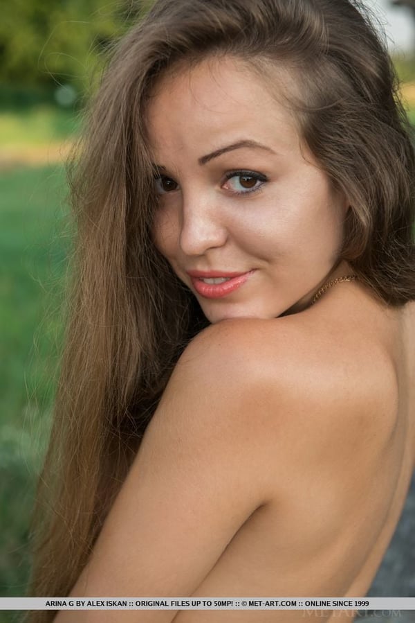 Picture by glambabes-galleries showing 'Young sweetie Arina G revealing freshly trimmed bush outdoors in the grass' number 16