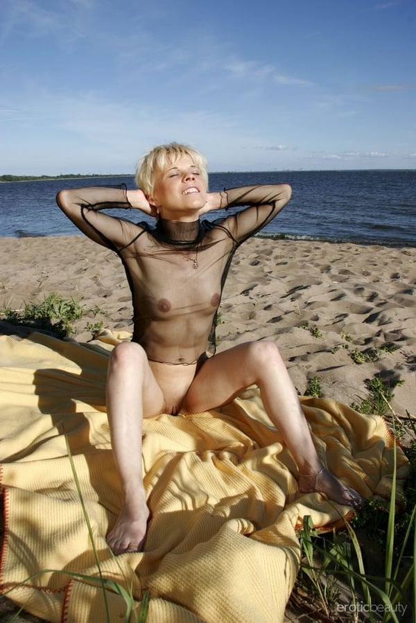 Picture by glambabes-galleries showing '30 plus blonde shows her shaved pussy in sheer attire on a secluded beach' number 4