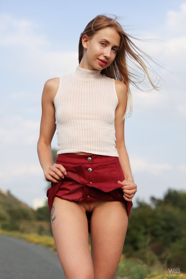 Picture by glambabes-galleries showing 'Charming blonde teen Anna Di hikes her skirt up with no panties on outdoors' number 11