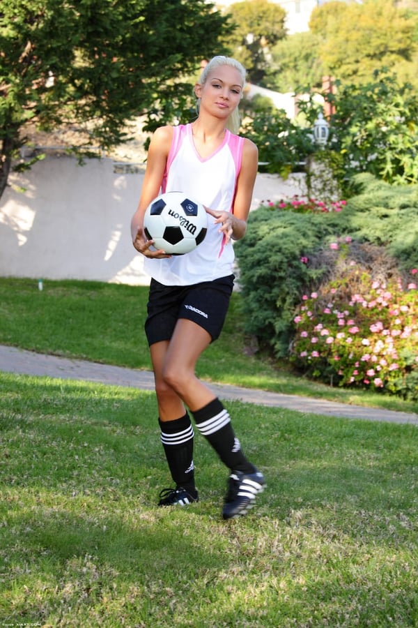 Picture by glambabes-galleries showing 'Skinny blonde girl uncovers tiny tits while bouncing a soccer ball outdoors' number 12