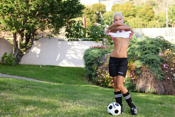 Picture by glambabes-galleries showing 'Skinny blonde girl uncovers tiny tits while bouncing a soccer ball outdoors' number 10