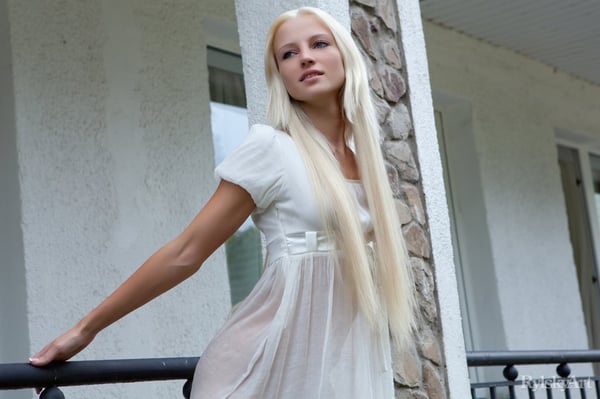 Picture by glambabes-galleries showing 'Innocent blonde teen from Estonia frees her girl parts from her white dress' number 14