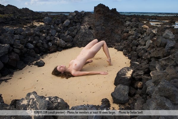 Picture by glambabes-galleries showing 'Tall girl with legs that go on forever poses totally on Basalt ringed sand pit' number 1