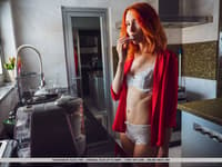 Young redhead Elin Dane gets totally naked on her bed over a hot beverage
