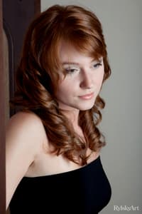 Natural redhead Nomi pulls down and hikes up her black dress to show her wares