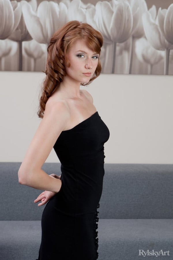 Picture by glambabes-galleries showing 'Natural redhead Nomi pulls down and hikes up her black dress to show her wares' number 14