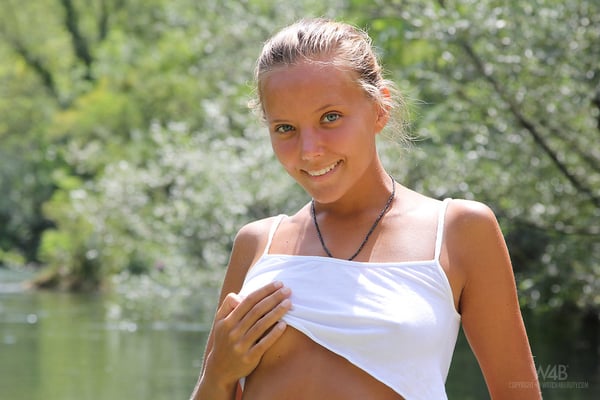 Picture by glambabes-galleries showing 'Sexy teen girl gets caught bathing naked in a shallow river by rafters' number 14