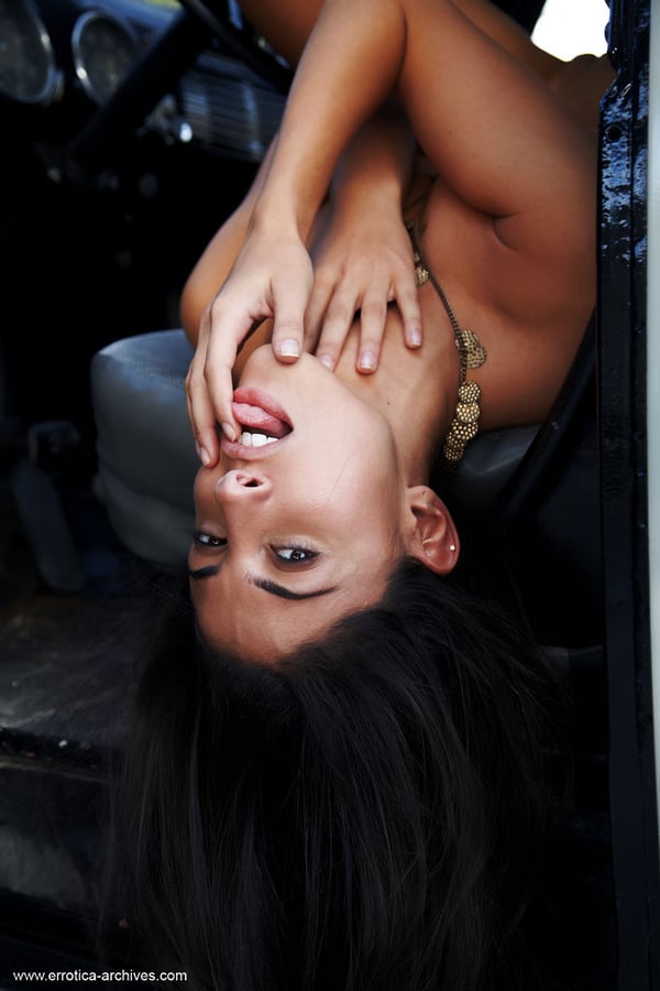Picture by glambabes-galleries showing 'Sexy brunette Nadia models naked inside a vehicle while wearing suede boots' number 16