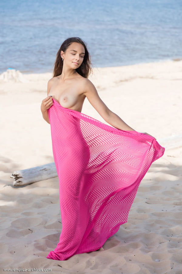 Picture by glambabes-galleries showing 'Sweet teen Slava A frees tan lined body from pink wrap on a beach' number 14